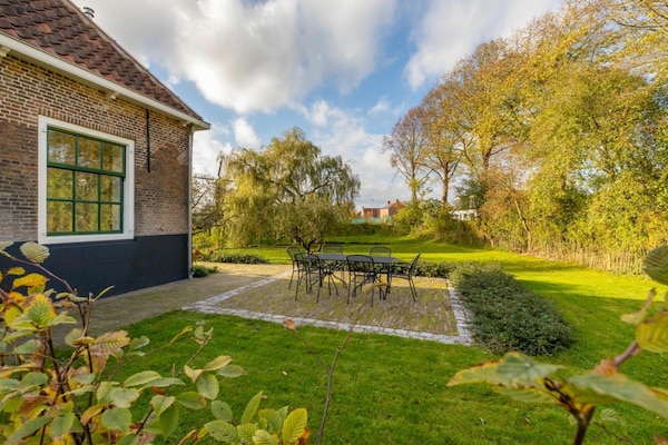 Foto van Boerderij in Zeeland met molenuitzicht - Vakantiehuis in Heinkenszand - GardenSummer