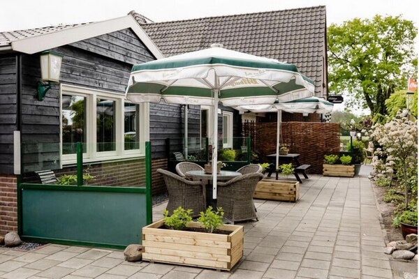 Foto van 2 modern verbouwde vakantiehuisjes naast elkaar in landelijke omgeving - TerraceBalcony